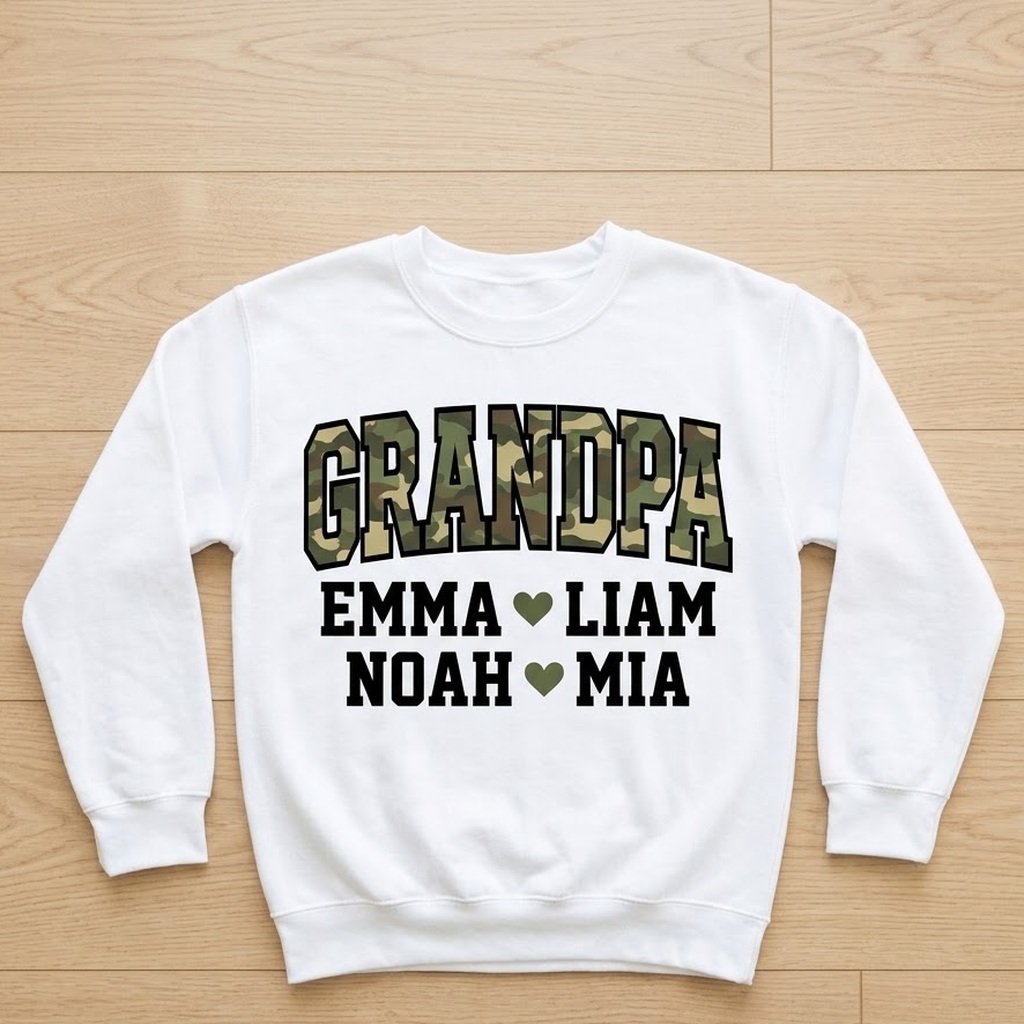 White grandpa camo sweatshirt laid flat on light wood with four grandkids names