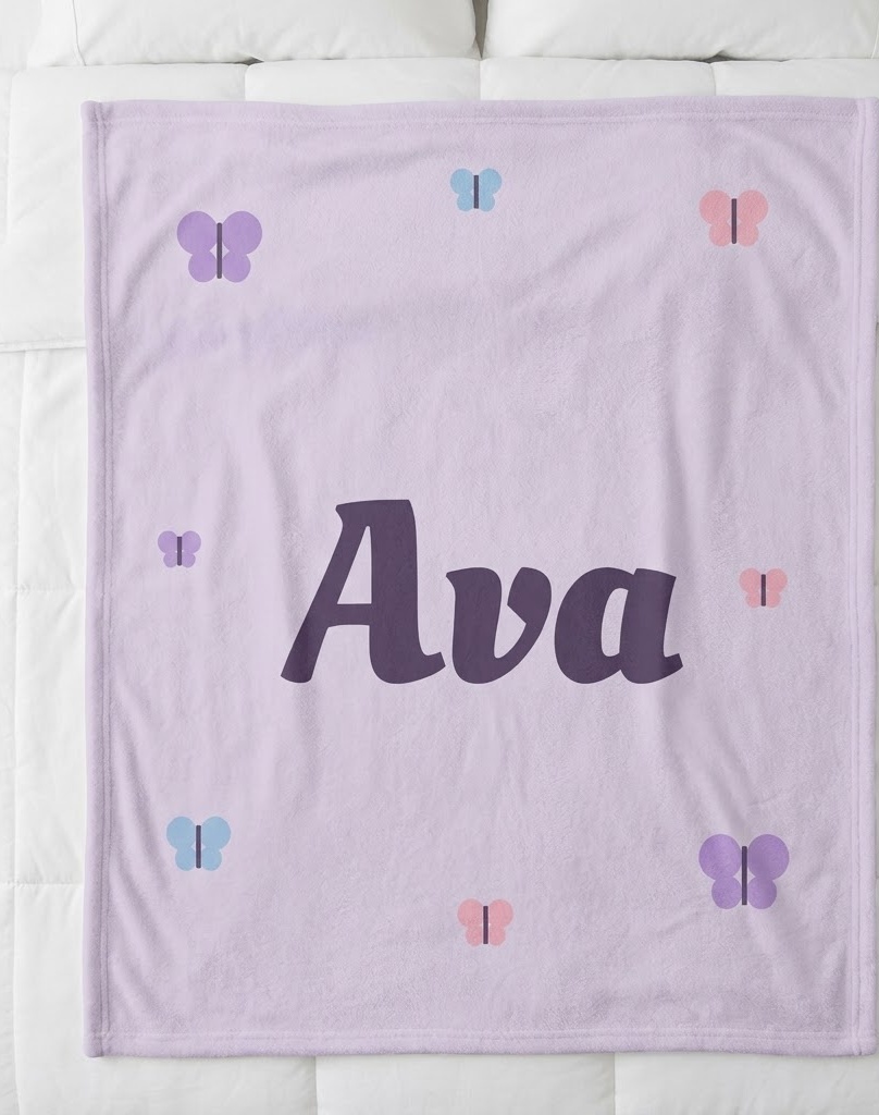 Butterfly name blanket with Ava in plum script on lavender, flat on a bed