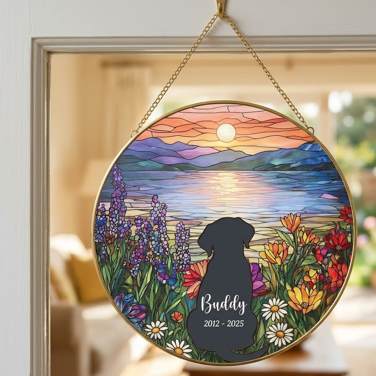 Dog memorial suncatcher with Buddy 2012 - 2025 hanging in a sunny window