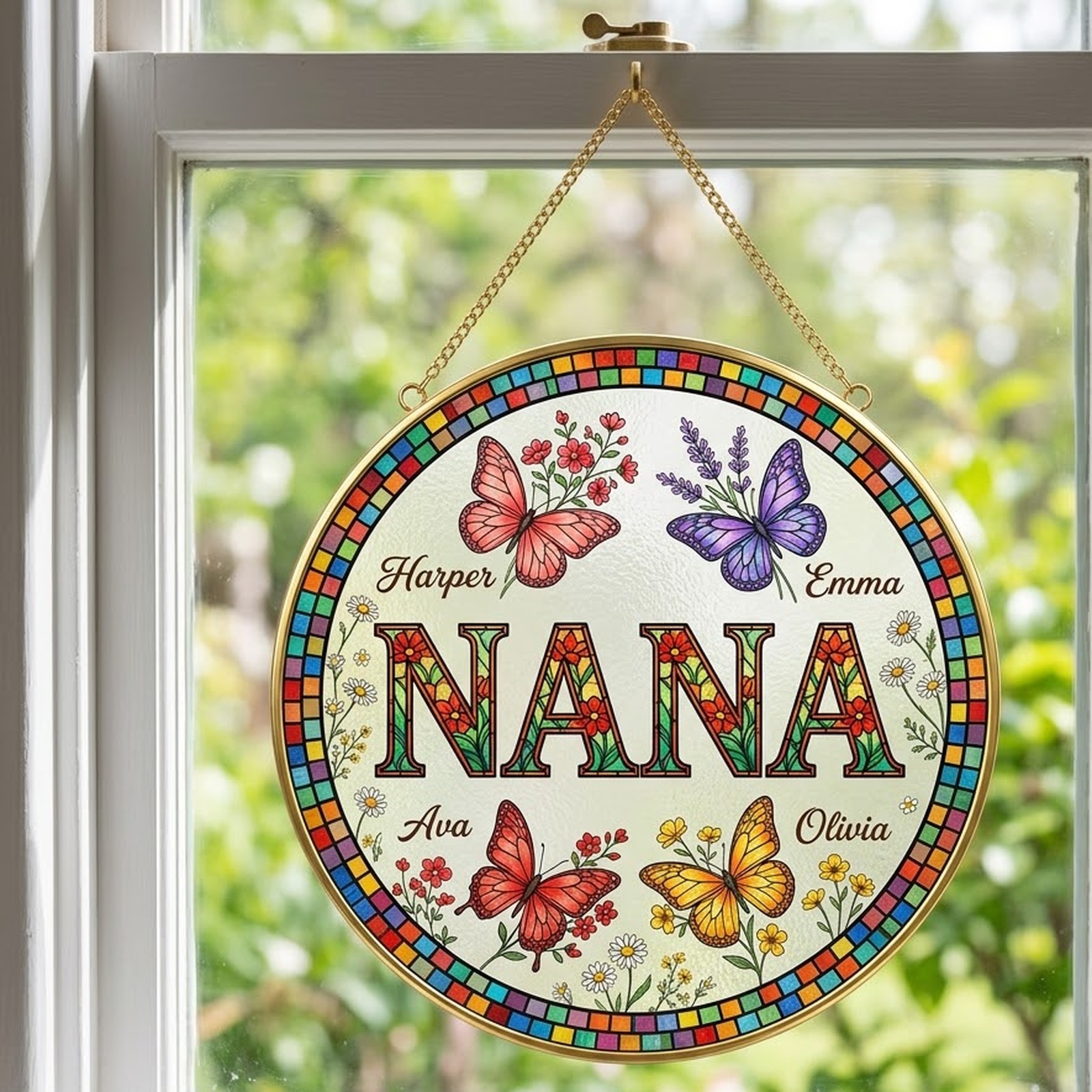NANA butterfly birth flower suncatcher hanging on a gold chain in a sunny window
