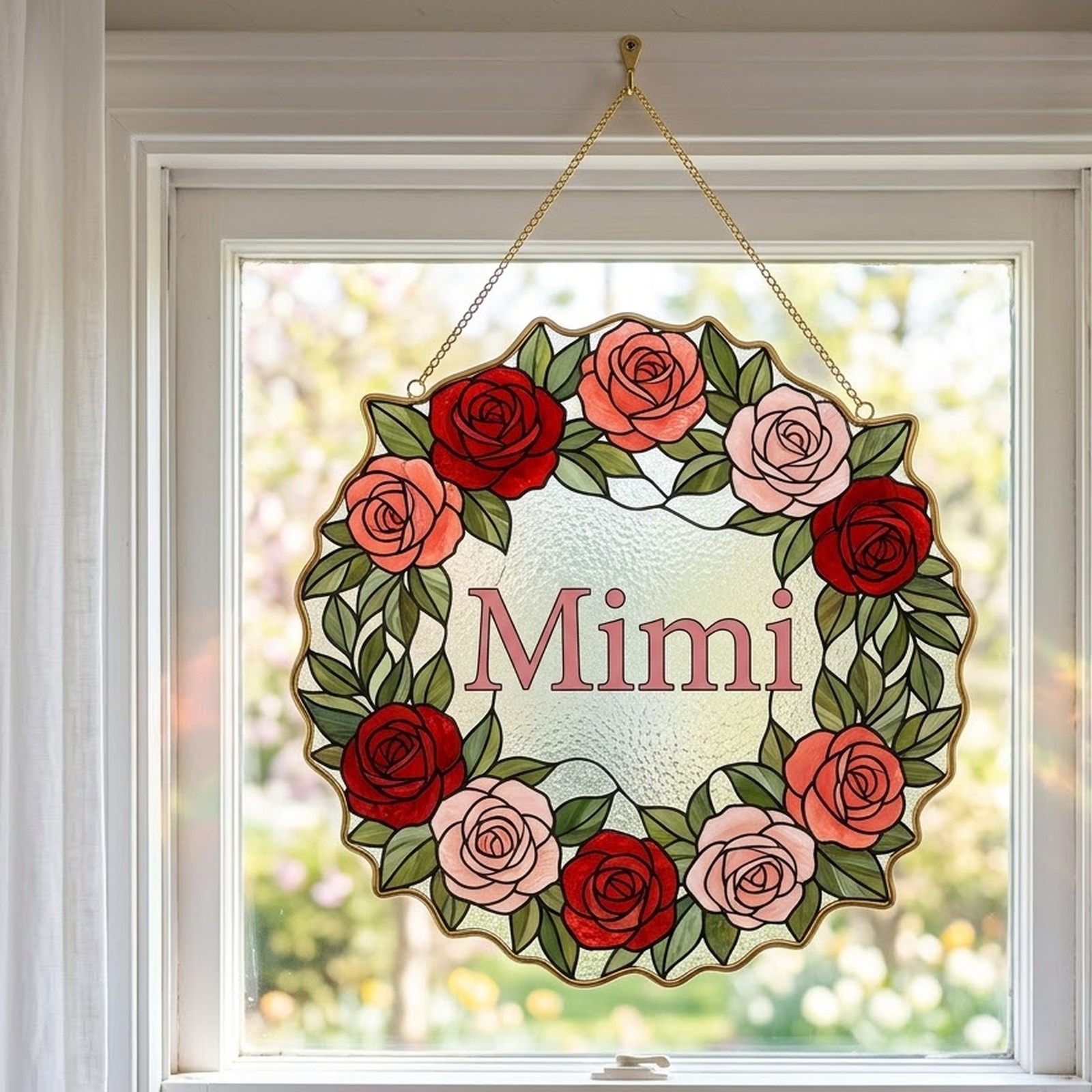 Mimi rose wreath suncatcher hanging on a gold chain in a sunny window